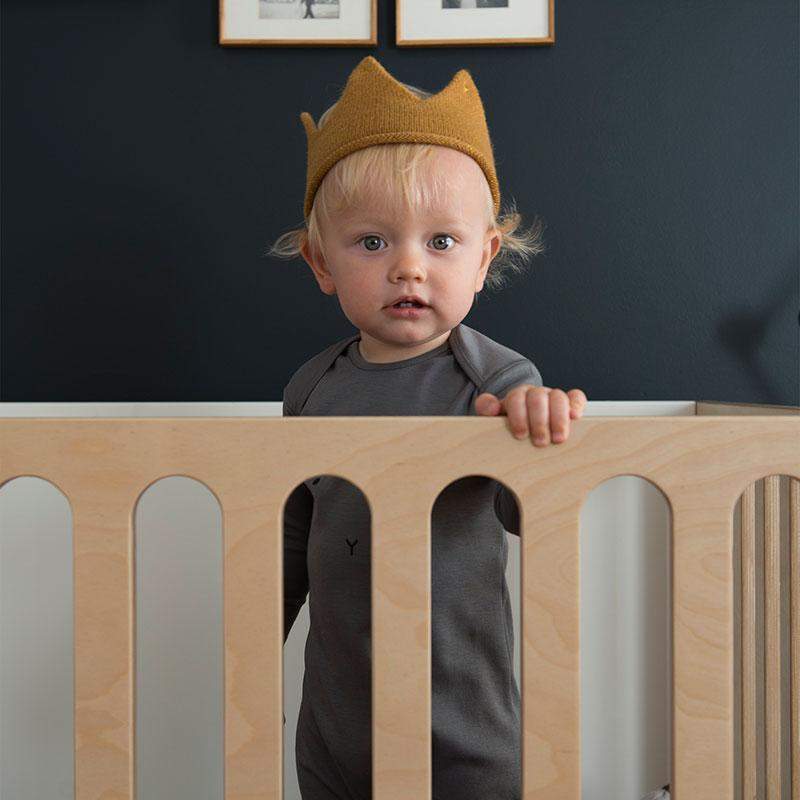 Child in crown in Oeuf fawn crib