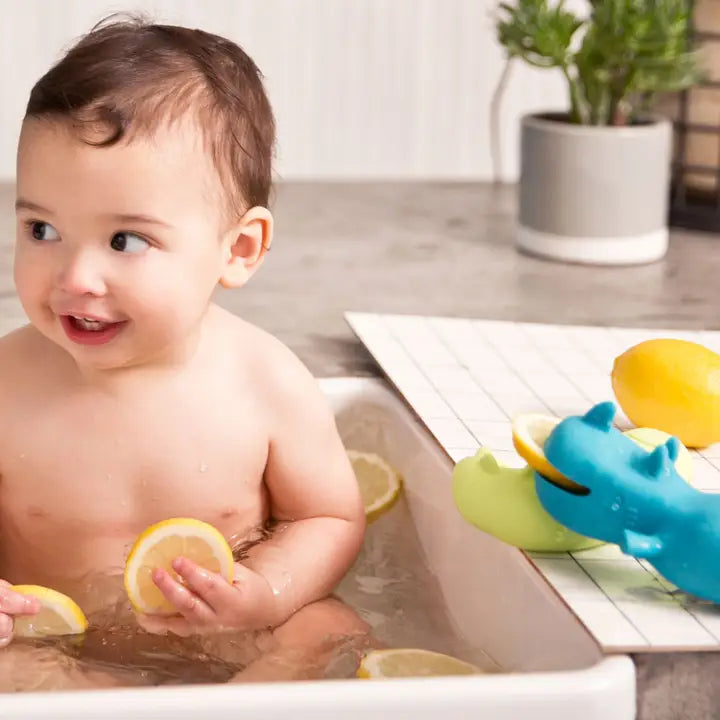 baby playing with bath toys