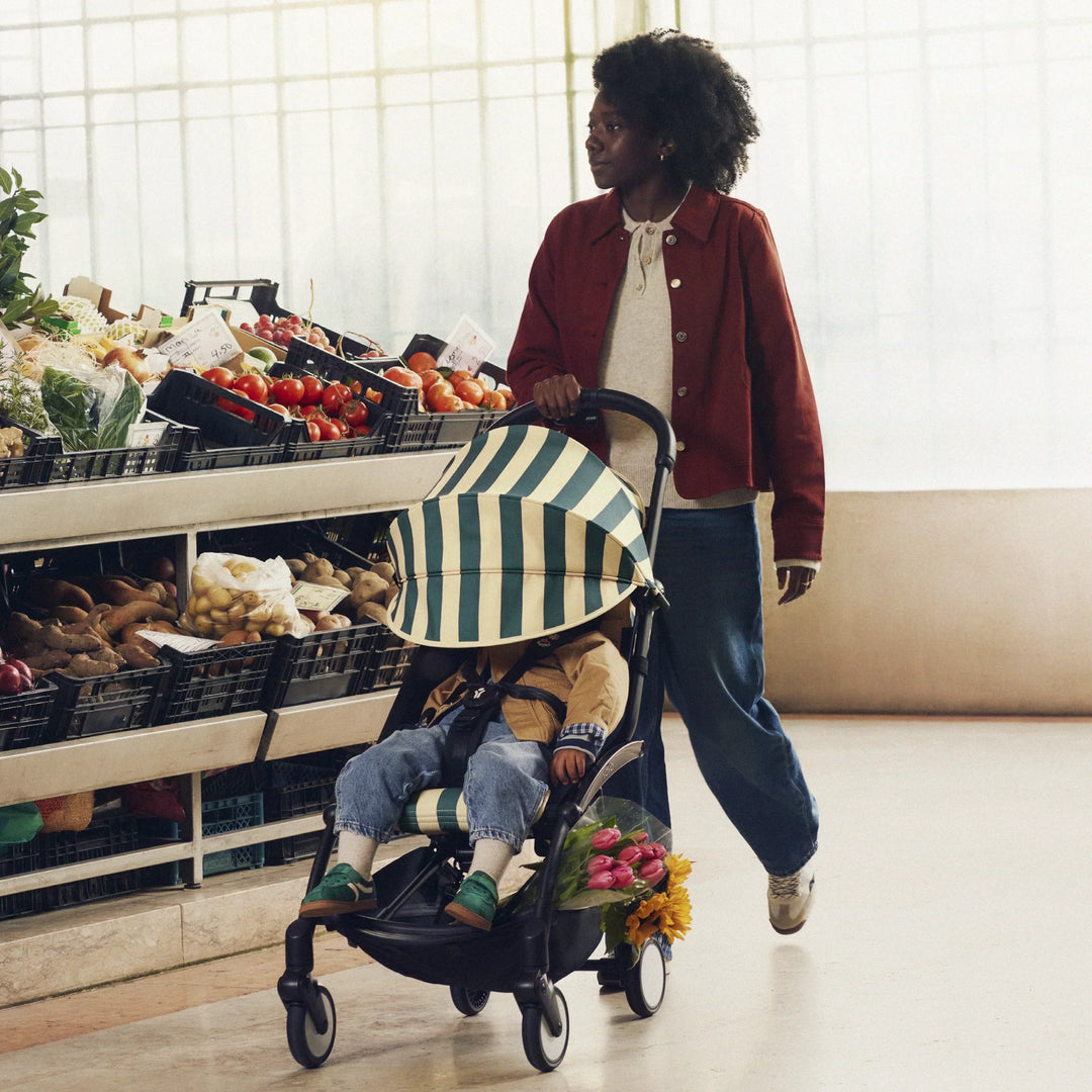 woman pushing yoyo riviera stroller by stokke
