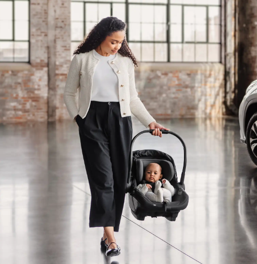 mother holding aria car seat with baby 