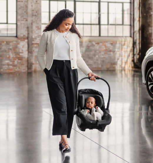 woman holding aria 2 infant car seat