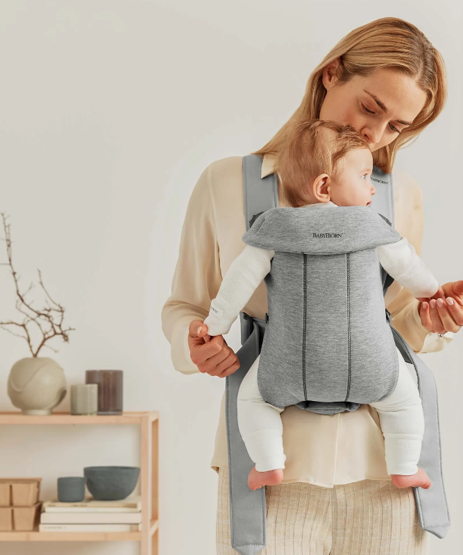 woman wearing baby bjorn mini carrier