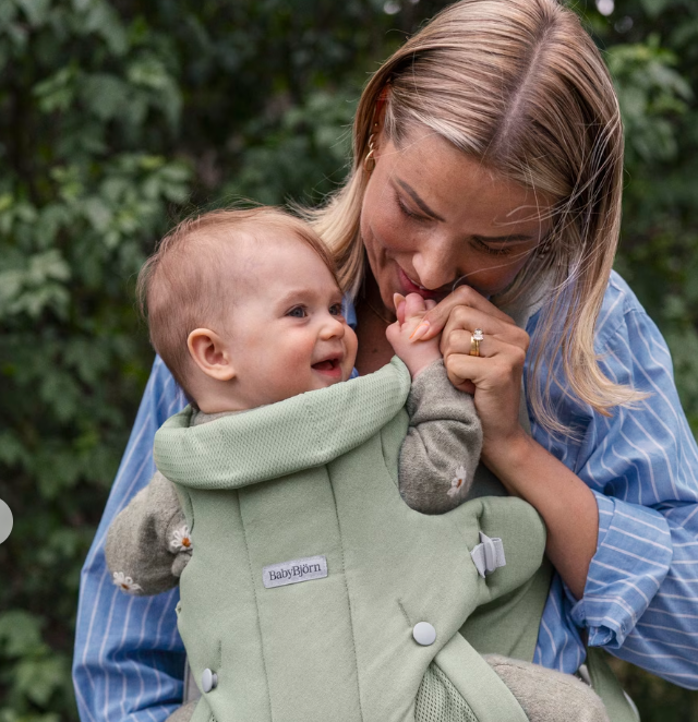 woman wearing baby bjorn hold carrier