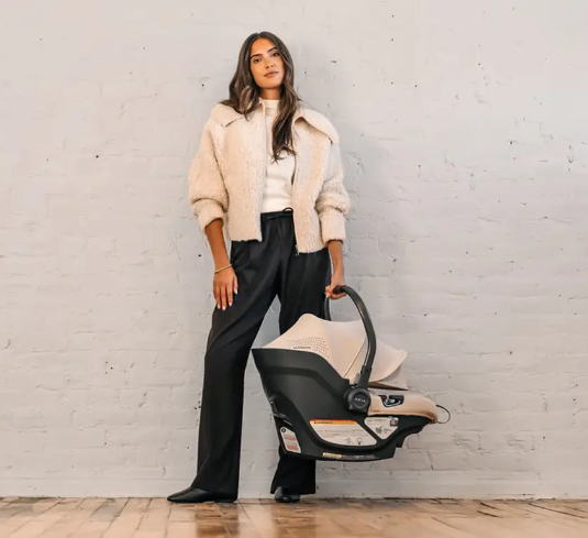 mother holding infant car seat aria uppababy