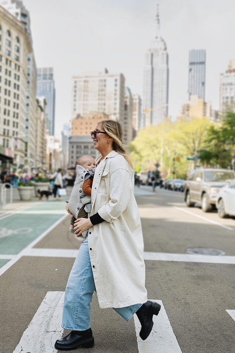 woman wearing harmony carrier baby bjorn