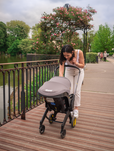 woman pushing a doona infant car seat stroller