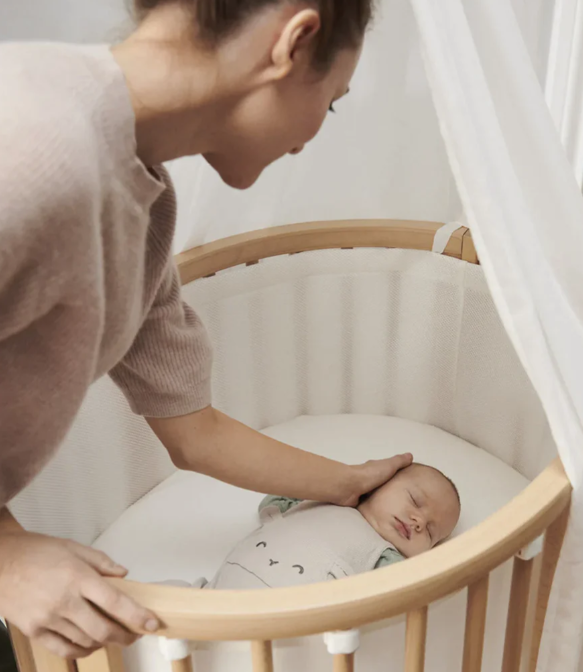 woman with baby and sleepi mini crib