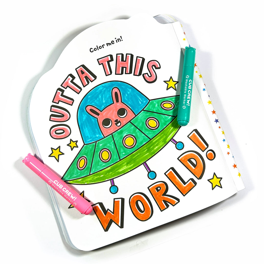 Coloring book with a cartoon alien spaceship and two markers on a white background