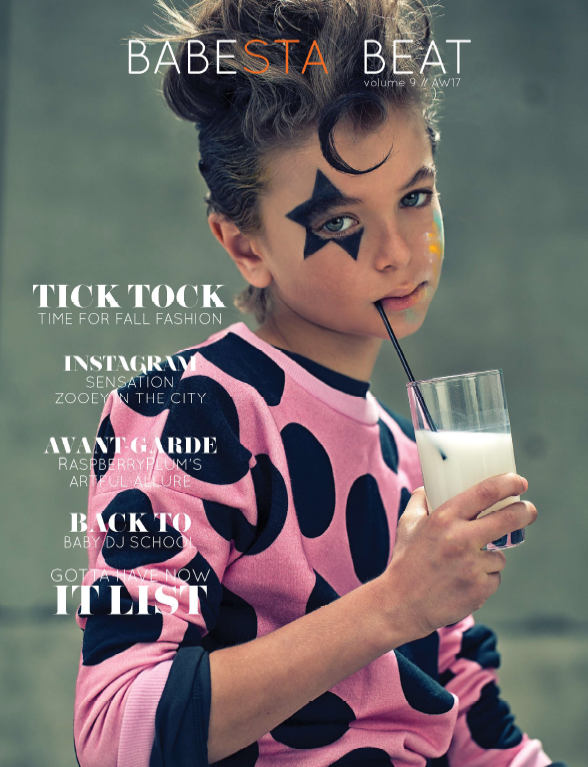 Magazine cover with a child in a polka dot outfit holding a glass of milk.