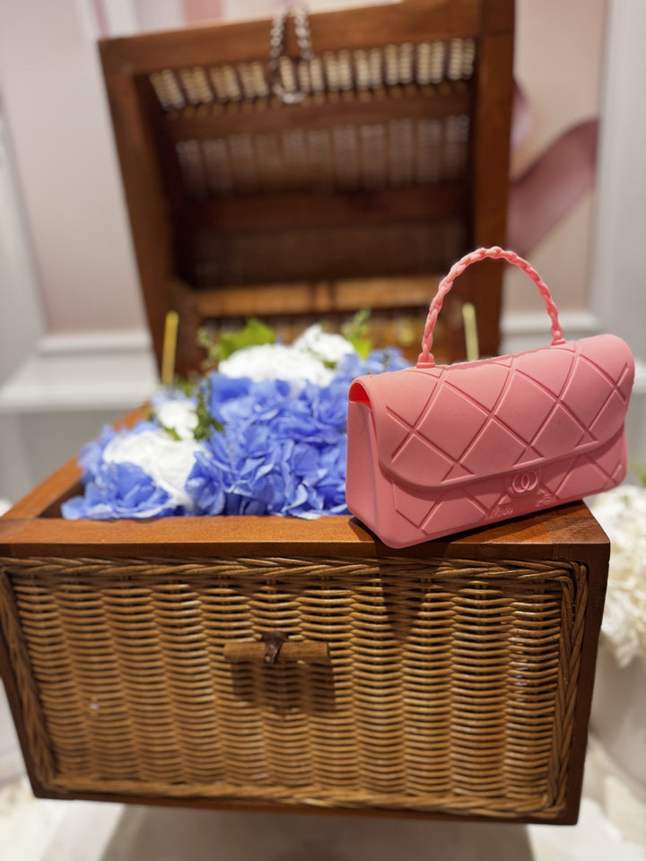 Pink quilted handbag Chanellini snack tote by Moonfare on a wooden basket with flowers