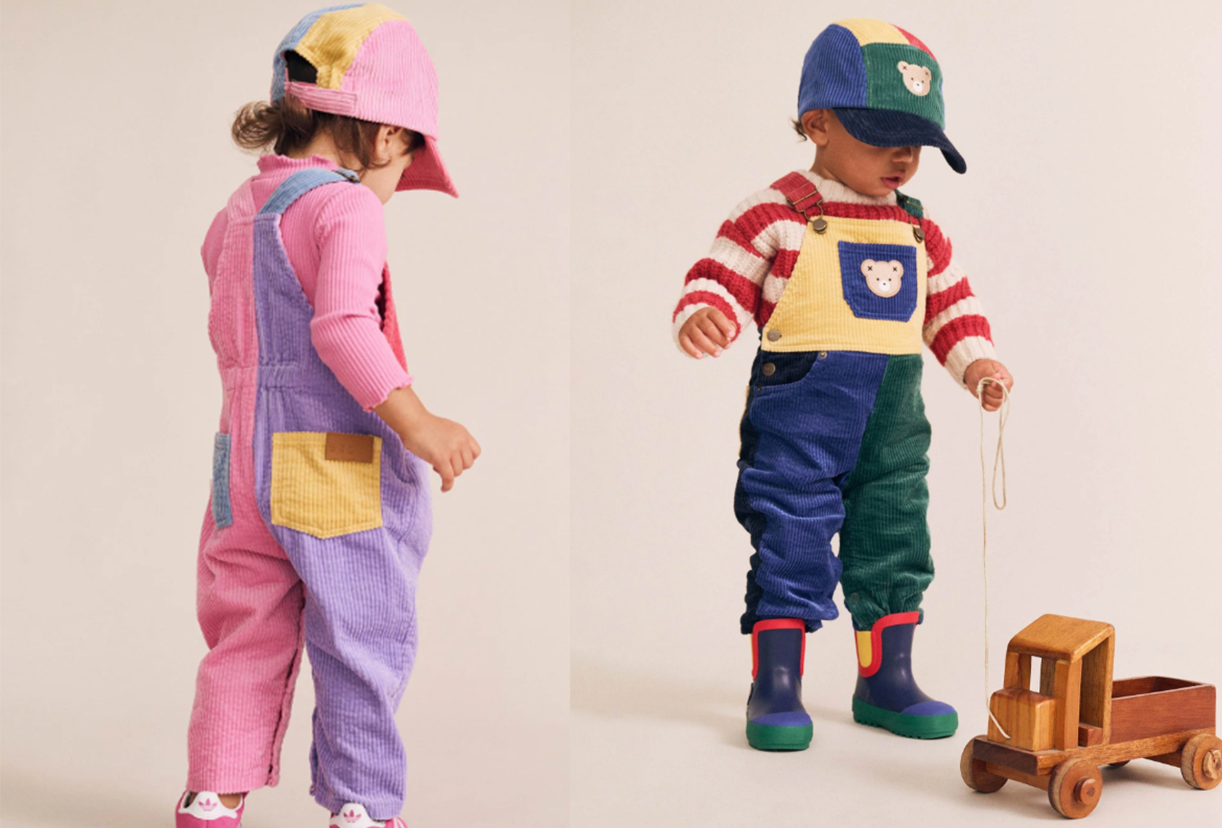 Two children in colorful outfits standing on a plain background