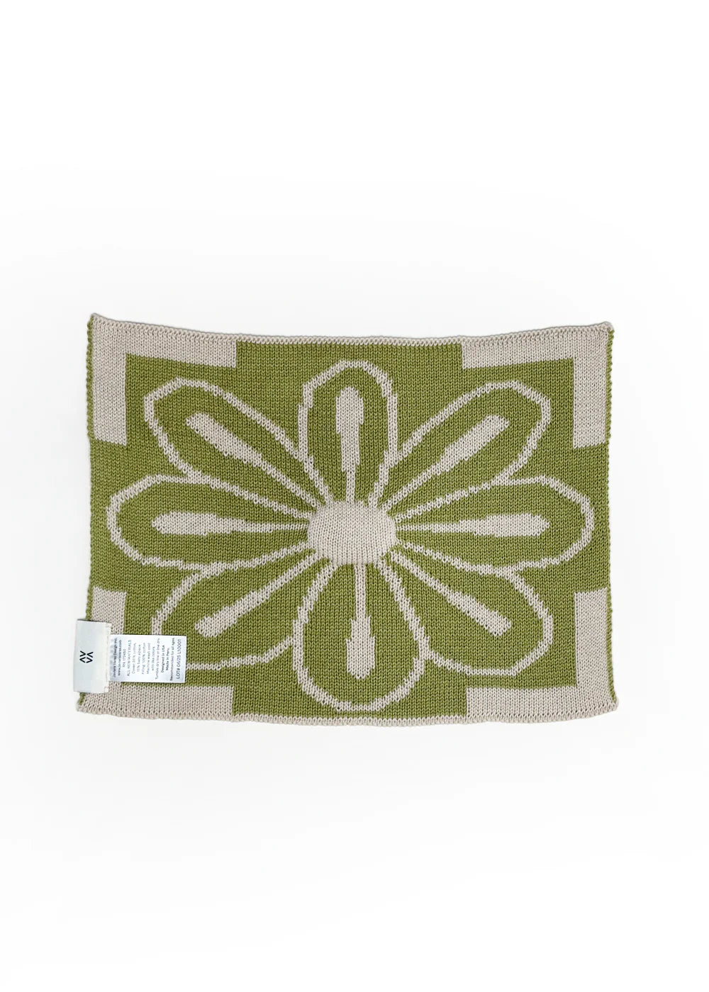 Knitted lovey by Javiera Varas with a green flower design  back
