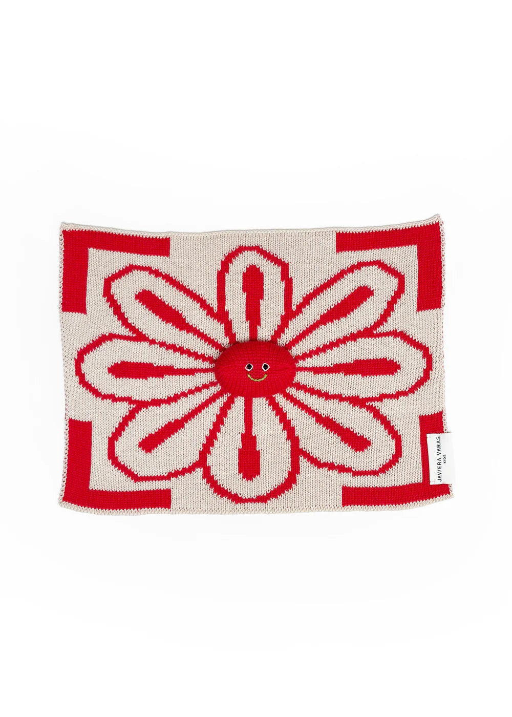 Red and white flower-shaped lovey by Javiera Varas with a smiley face on a white background