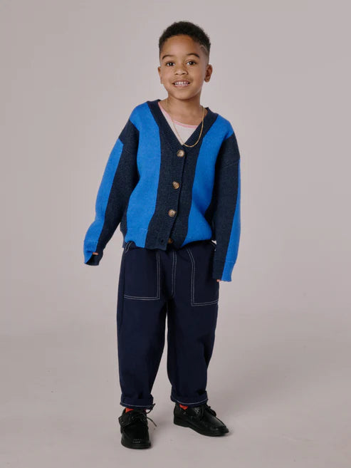 Children’s cardigan with bold blue stripes, button-up front, and relaxed fit, laid flat to show knit texture and design