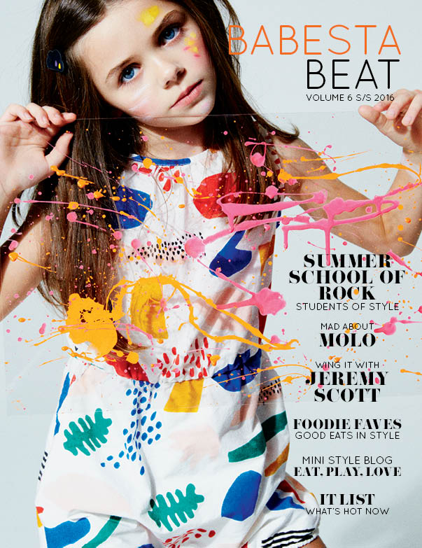 Magazine cover featuring a child in a colorful outfit with text about a 'Summer School of Rock' event.