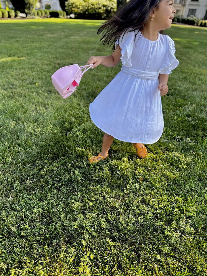 little girl holding the Birkkid tote snack handbag