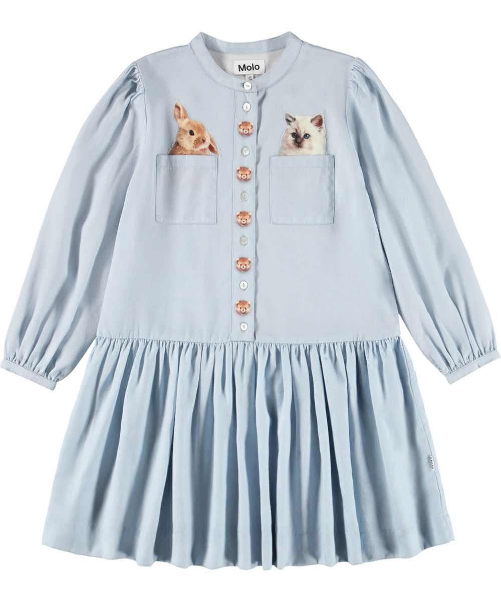 Nice light blue viscose dress. The dress has beautiful buttons at the front, two pockets and an attached circular skirt, as well as button closure at the sleeves. The dress has a print of cute animals by the buttons, as well as in the pockets.
