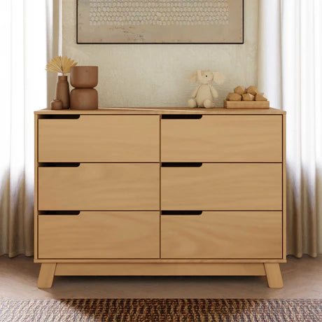 Wooden dresser with decorative items in a room setting
