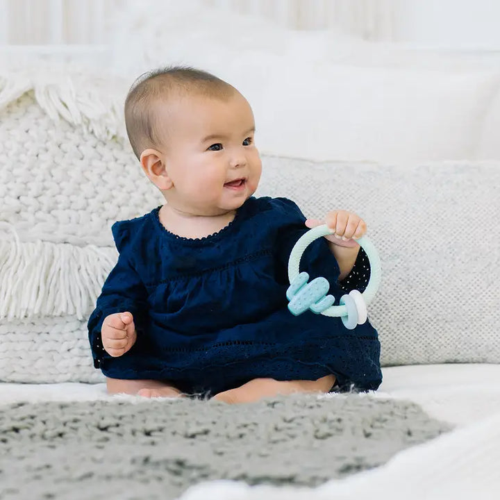 Baby Holding Cactus Silicone Teething Rattle by Itzy Ritzy