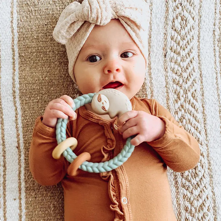 Baby Holding Sloth Silicone Teething Rattle by Itzy Ritzy