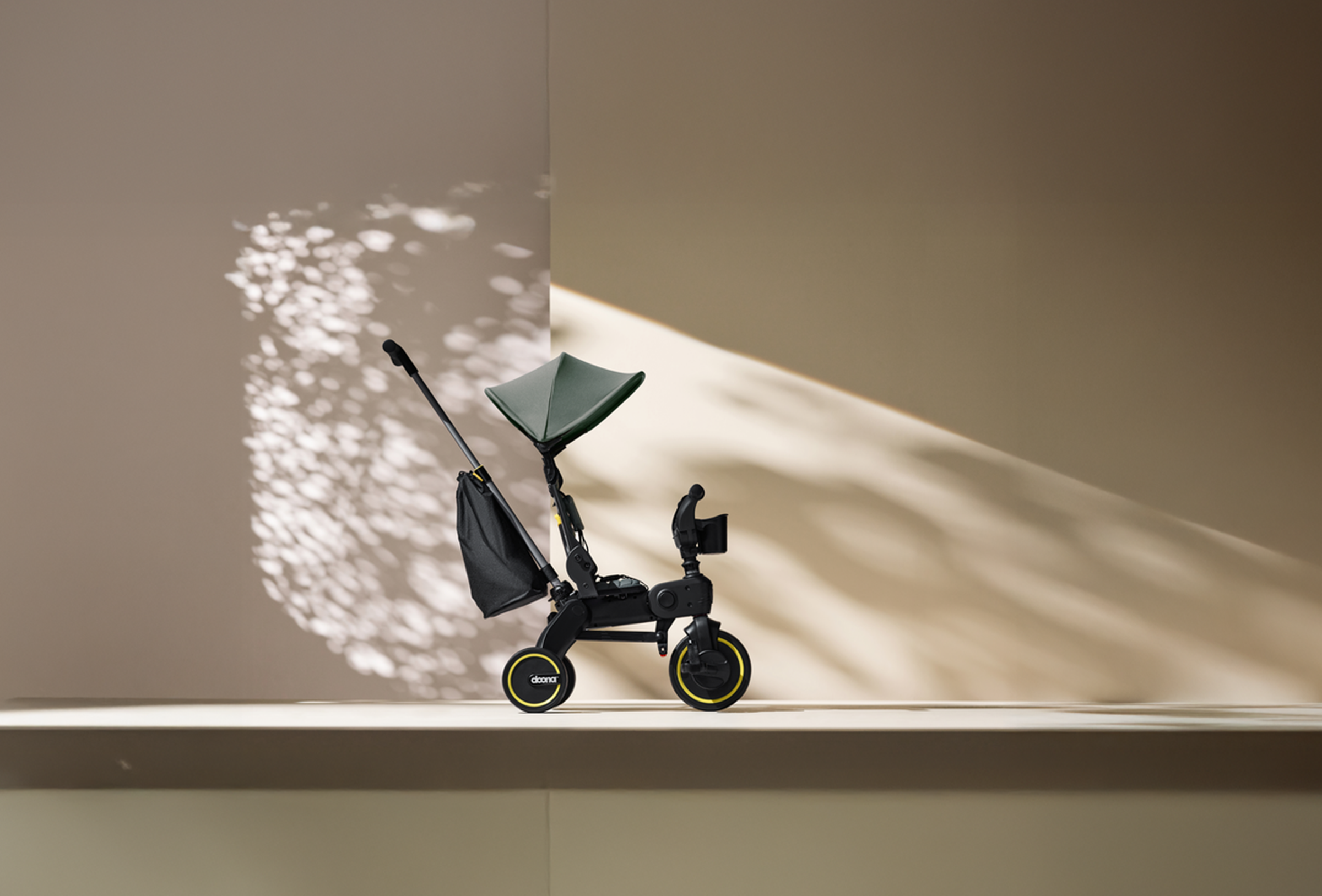 Black scooter with a green seat on a light-colored floor