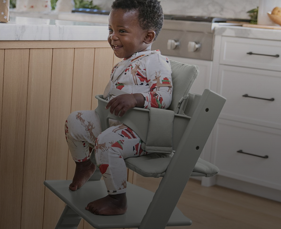 child sitting in tripp trapp high chair